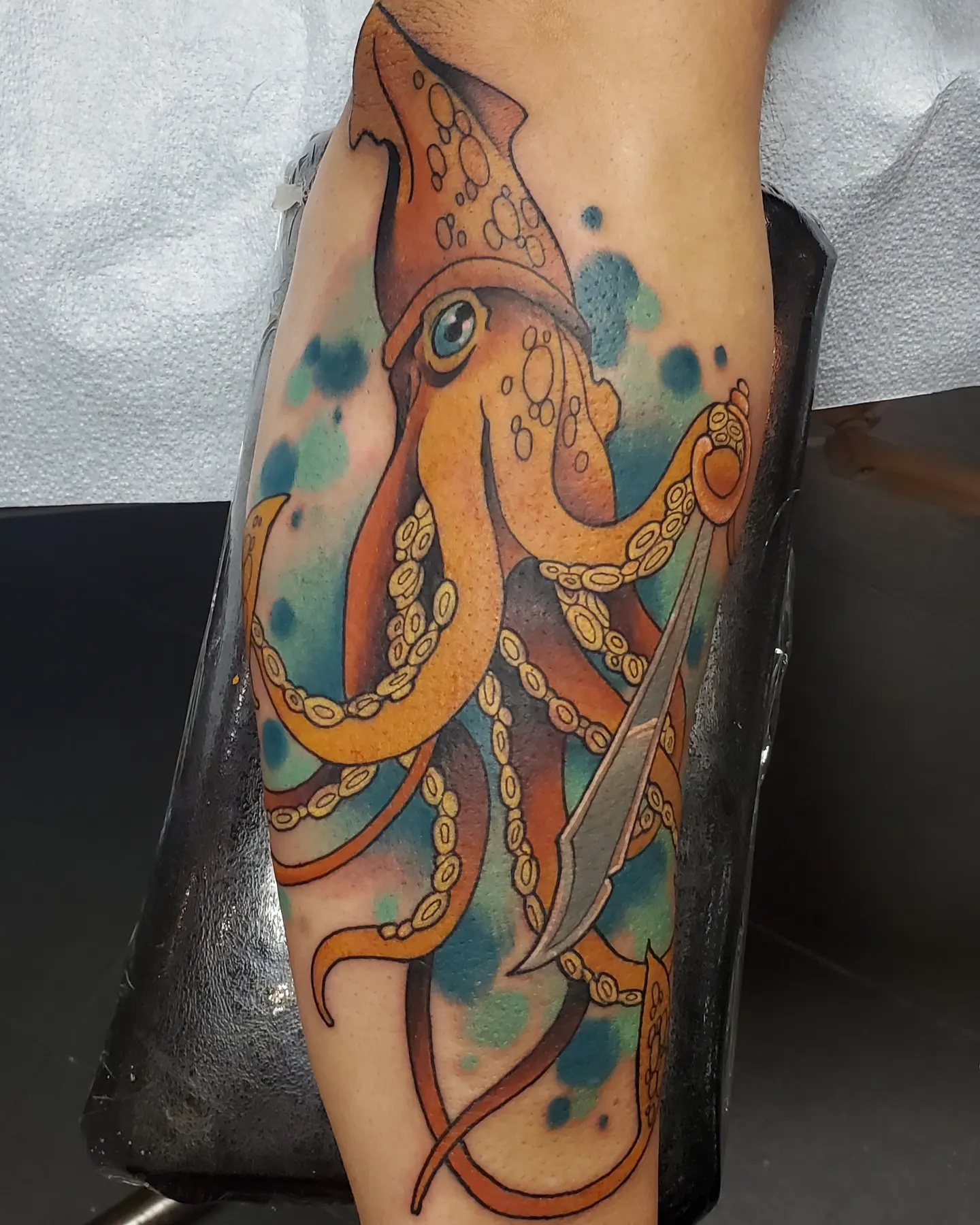 Squid with chain watercolor tattoo on the forearm by Brian Savage, Gilbert, Arizona