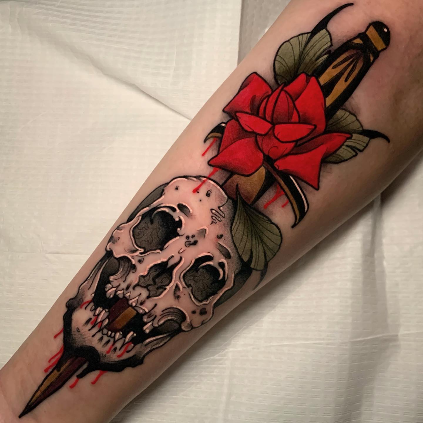 Skull and rose American traditional tattoo on the forearm by gillian marie