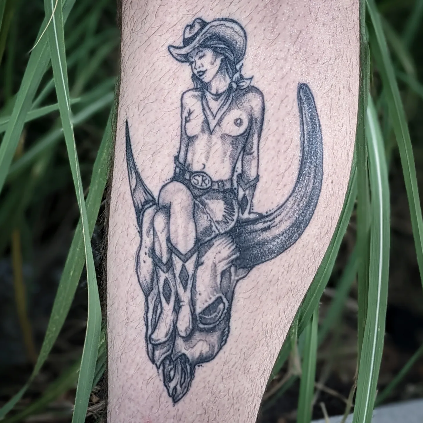 Cowgirl riding bull skull black and grey tattoo on the forearm by Gail Howard Perry III