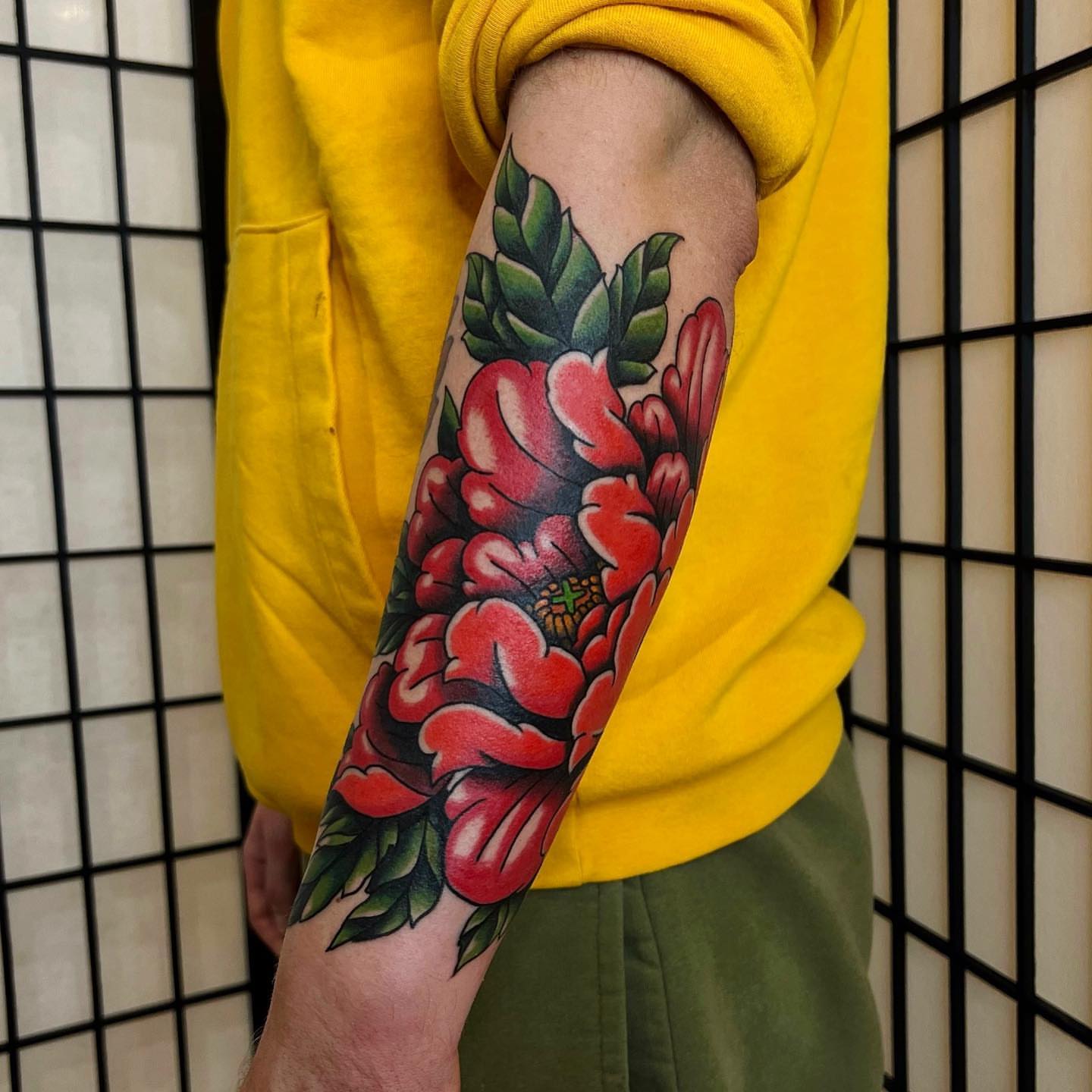 Red flowers American traditional tattoo on the forearm by David Mendieta