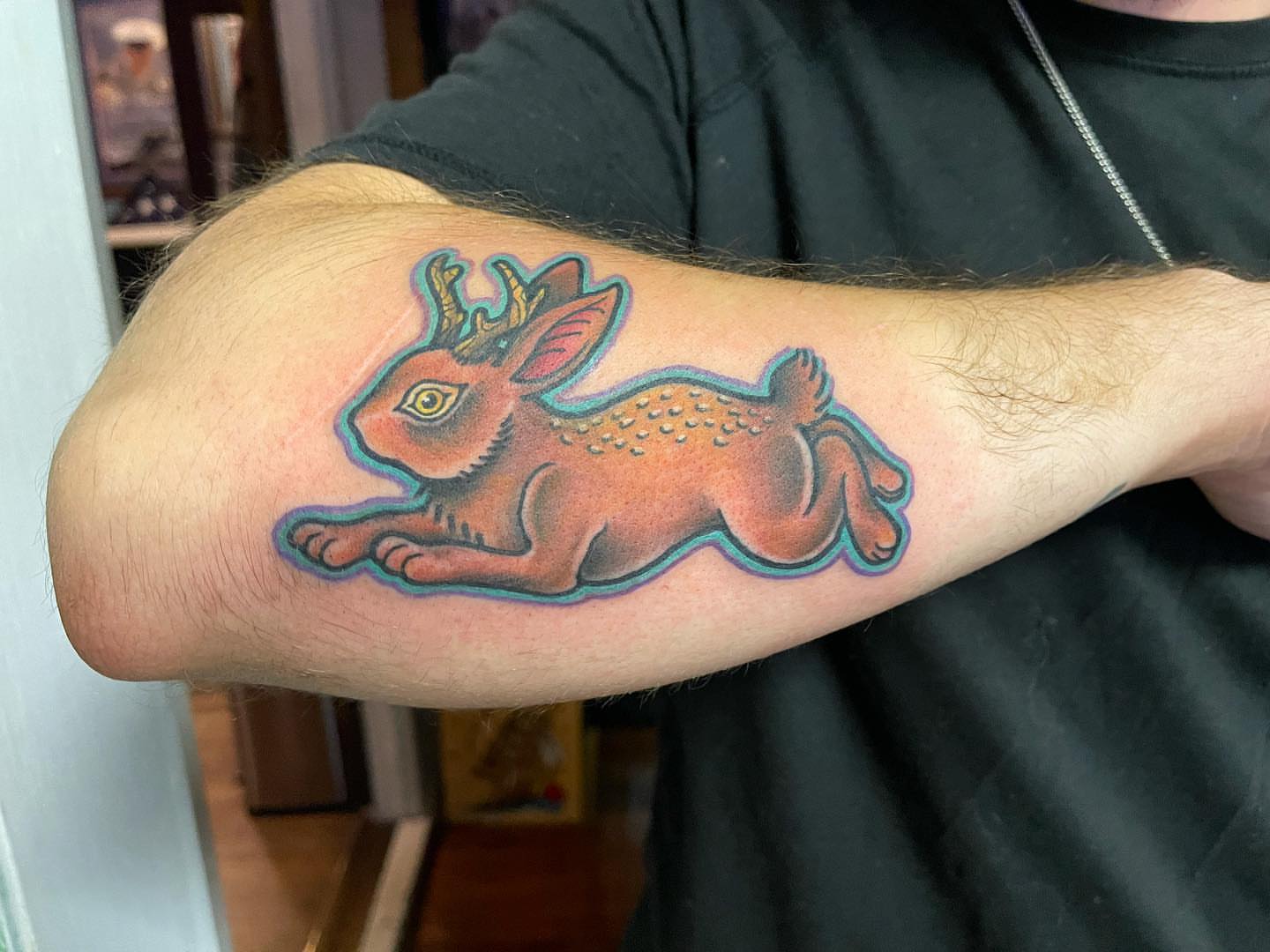 Rabbit with antlers American traditional tattoo on the forearm by Erin Miller