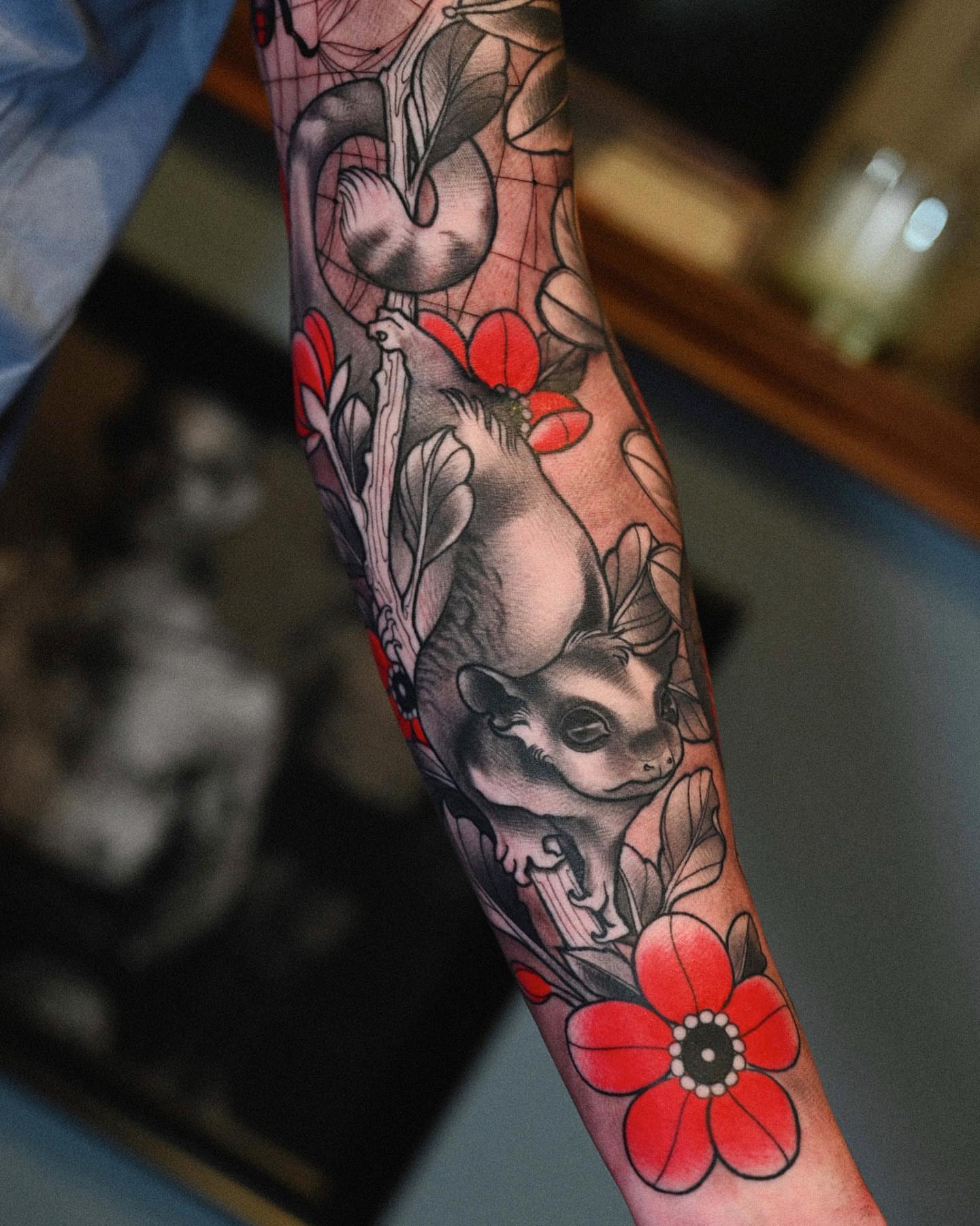 Squirrel and flowers American traditional tattoo on the forearm by Lorenzo Lopez