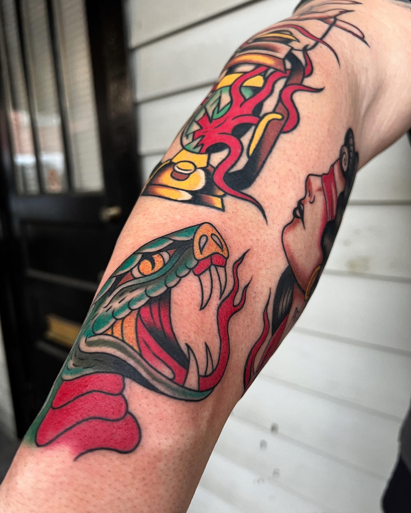 Snake American traditional tattoo on the forearm by Daniel Mesen