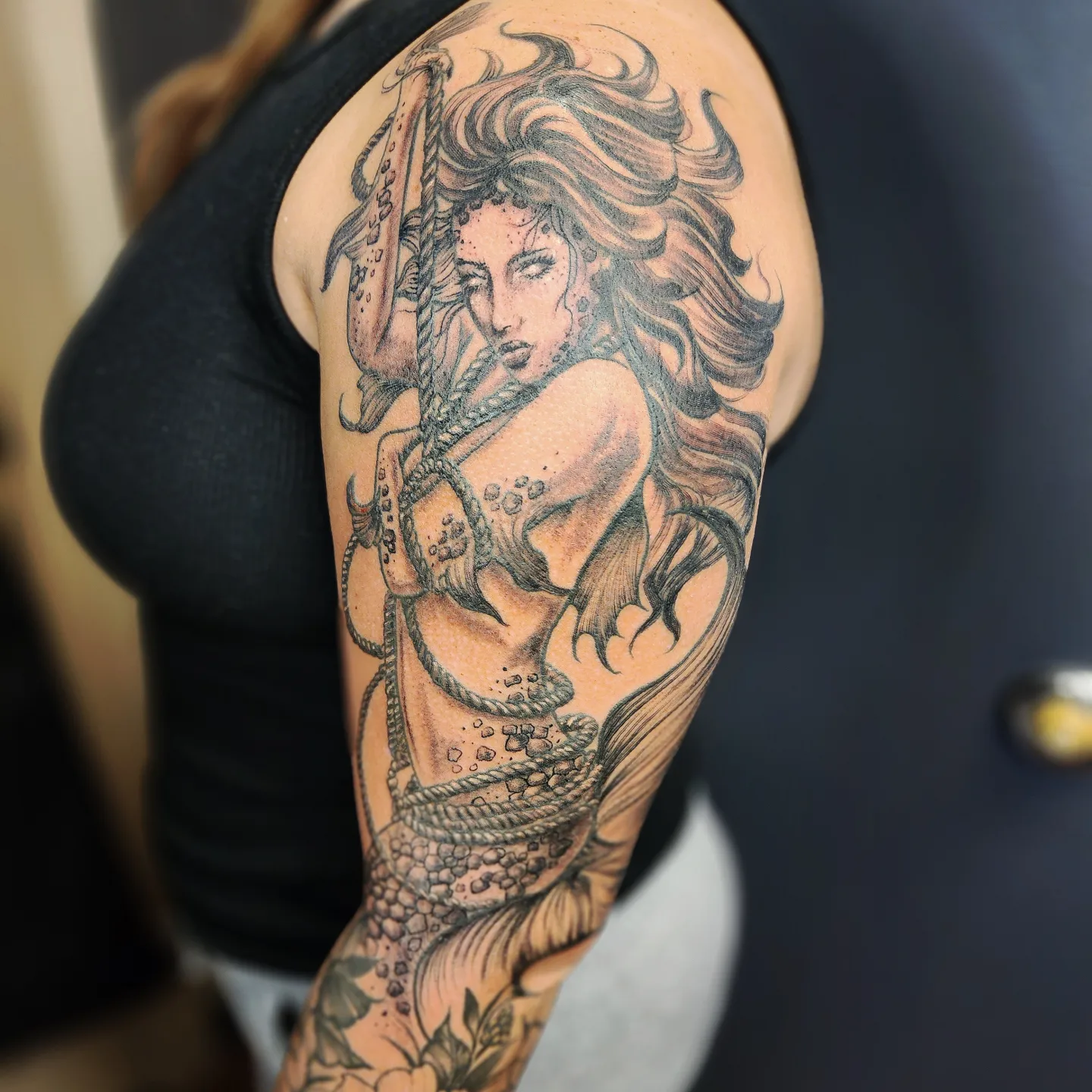 Mermaid realism tattoo on the upper arm by Neil Ohmie