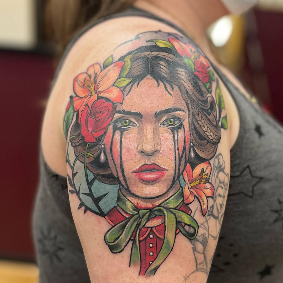 Portrait of a woman with flowers neo-traditional tattoo on the shoulder by Megan Merrell (Butler)