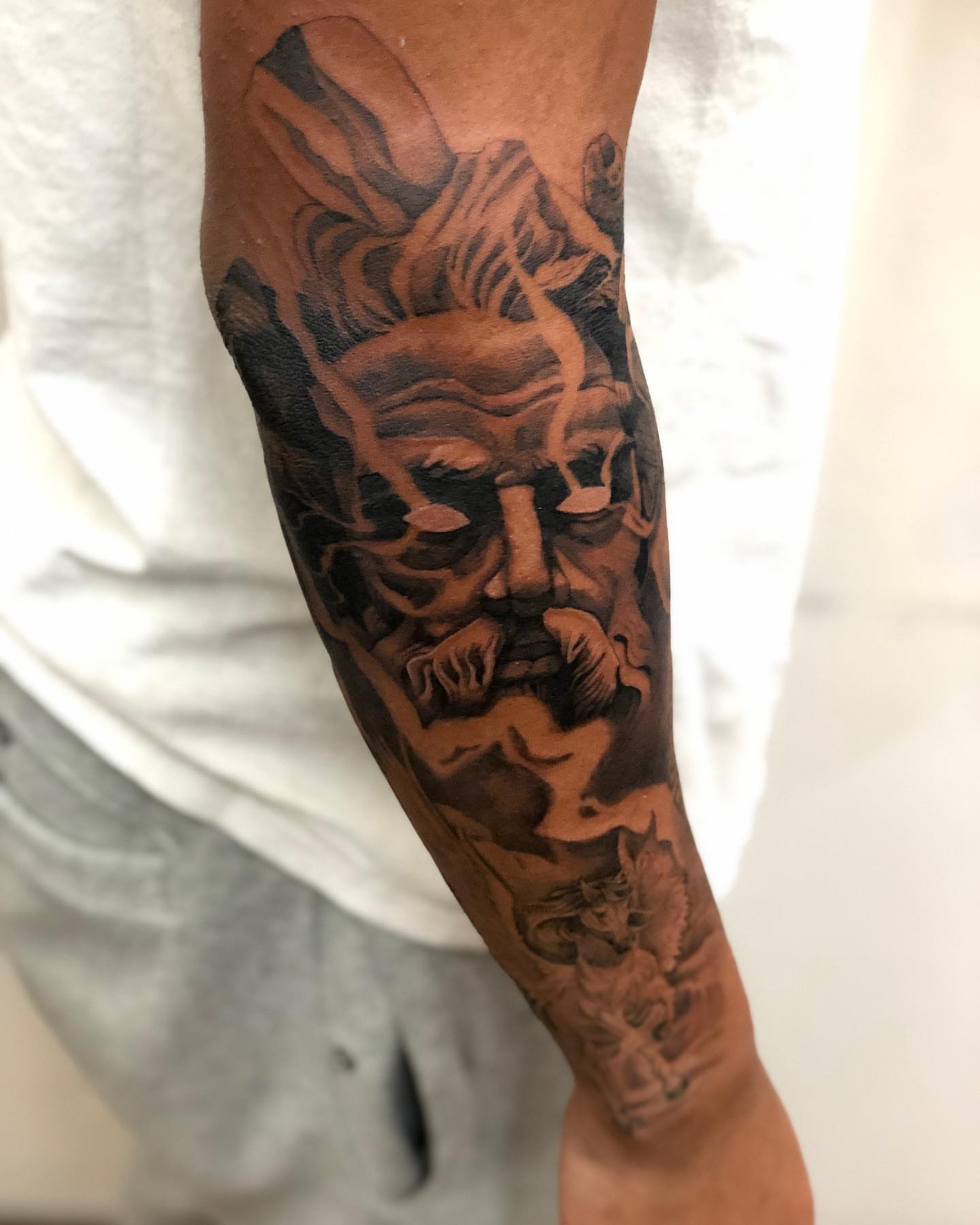 Mask black and grey tattoo on the forearm by Kevin Palma