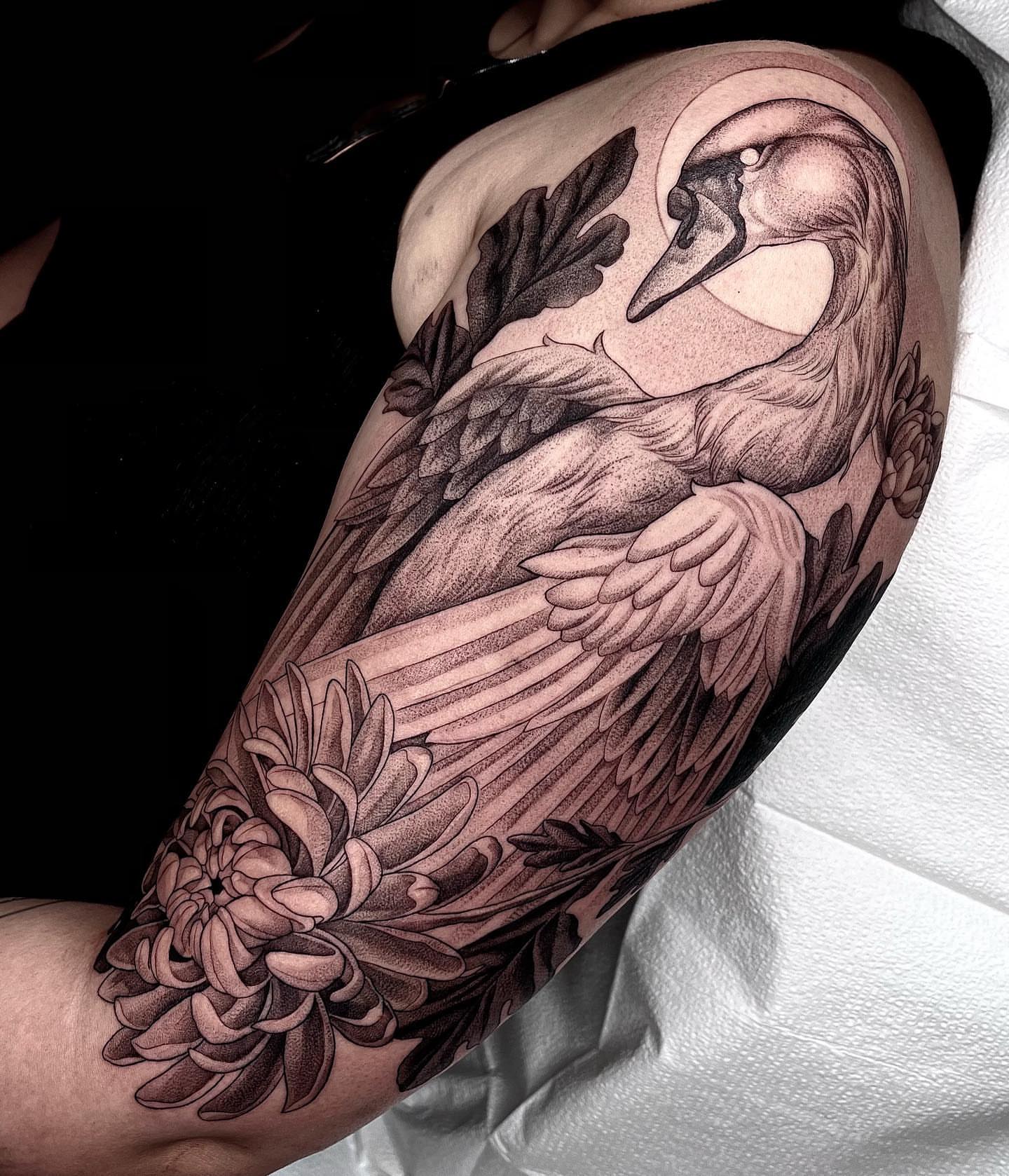 Swan and chrysanthemum dotwork tattoo on the forearm by Enrique Martinez