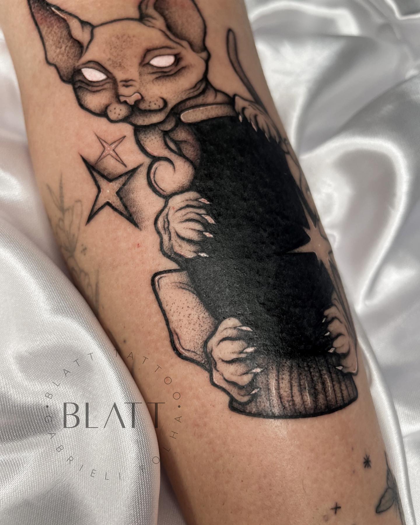 Cat black and grey tattoo on the forearm by Gabrieli Folha