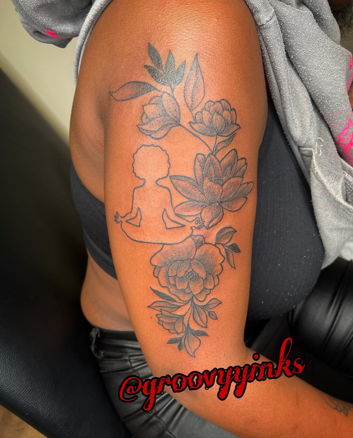 Flower and silhouette black and grey tattoo on the forearm by groovyyinkss
