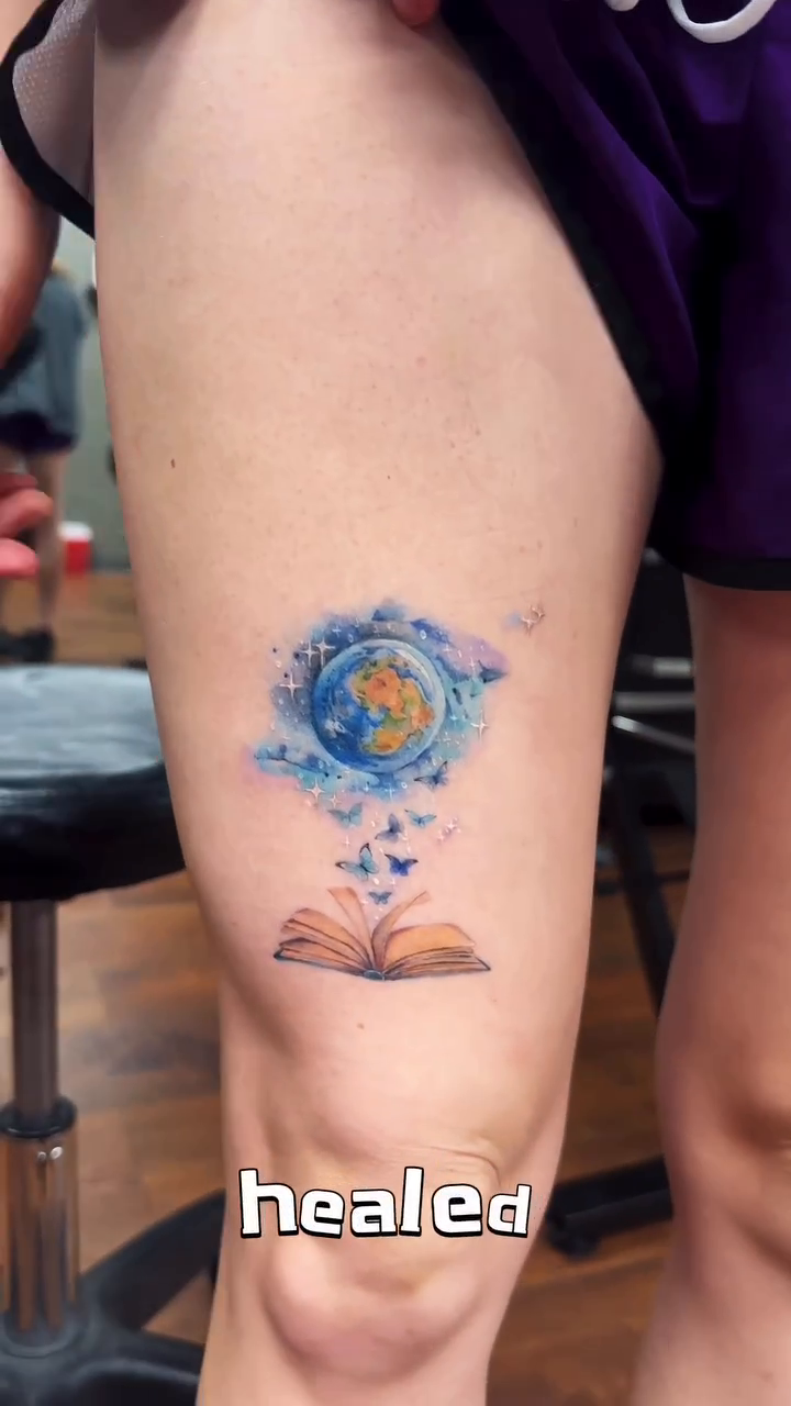 Globe and open book illustrative tattoo by Eva Liu