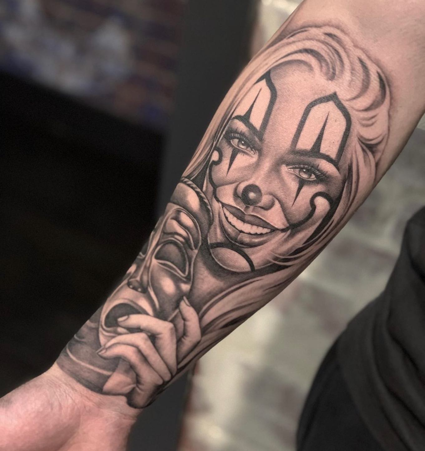 Clown black and grey tattoo on the forearm by 𝒲𝒾𝓃𝑜𝓃𝒶
