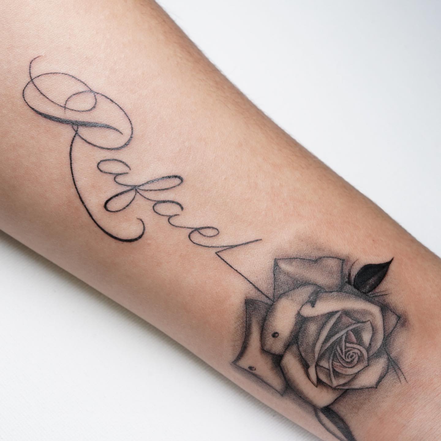 Rose and name black and grey tattoo on the forearm by Nj Tattoo Artist Inkdyou, Bloomfield, New Jersey