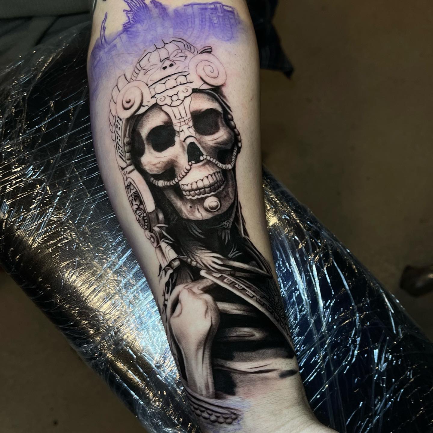 Skull wearing headdress realism tattoo on the forearm by Martin Reyes Jr