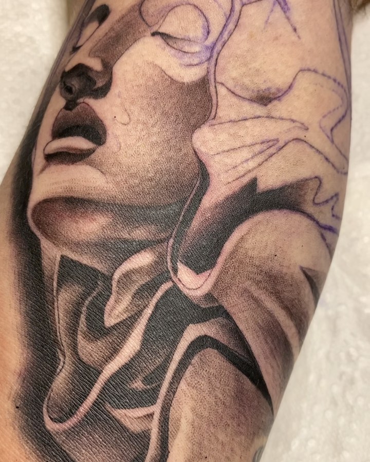 Abstract face realism tattoo on the forearm by LifesGrape