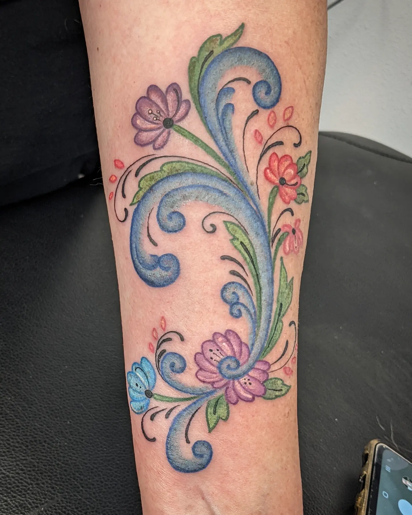 Floral vine ornamental tattoo on the forearm by Christel Perkins