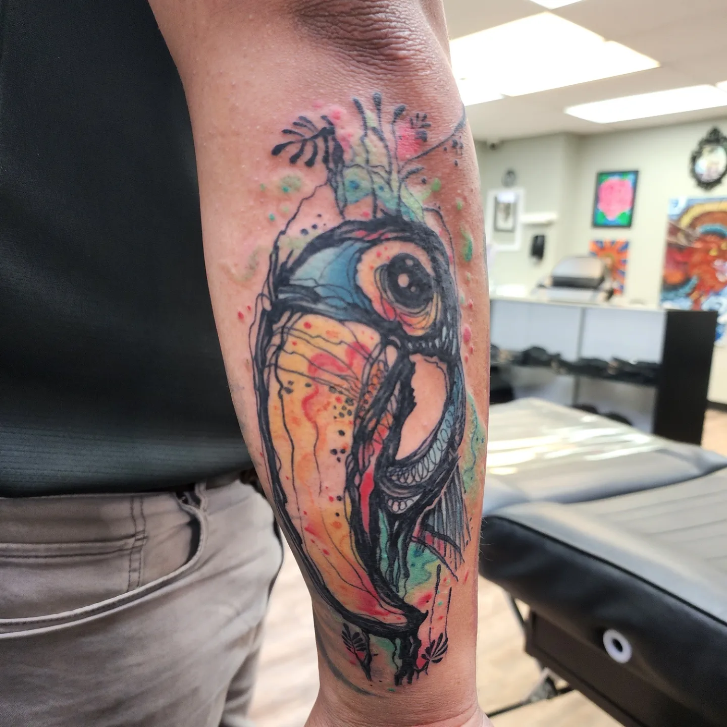 Bird watercolor tattoo on the forearm by André Brazil