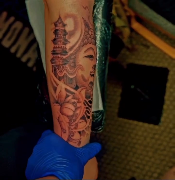 Buddha and pagoda sleeve Japanese tattoo on the forearm by @tattsbyleek