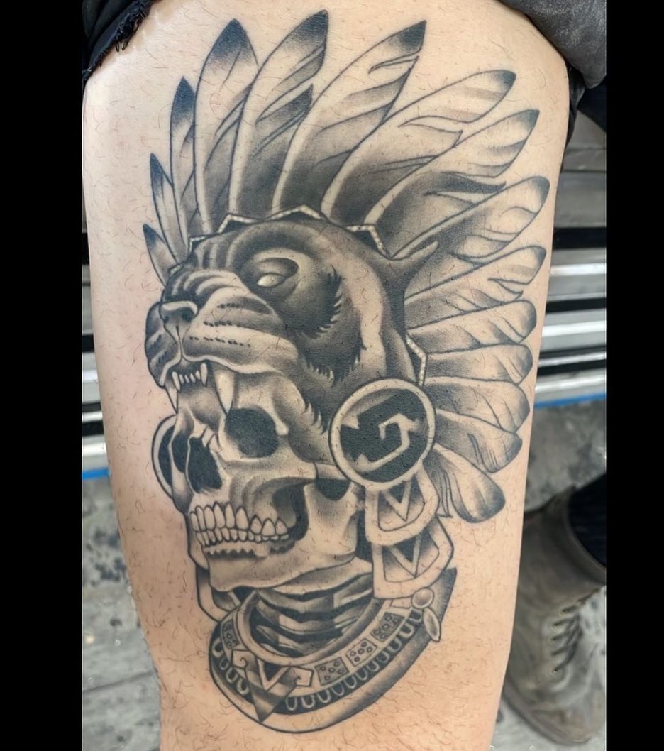 Skull with feathers realism tattoo on the thigh by LifesGrape