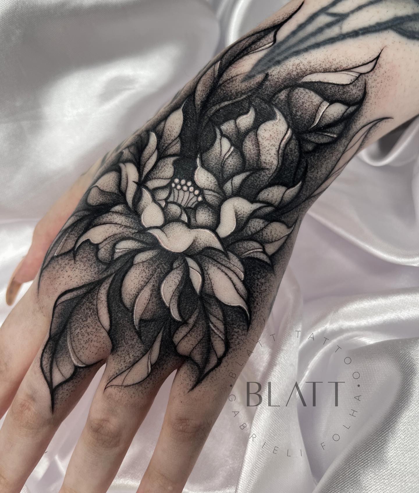 Lotus flower dotwork tattoo on the forearm by Gabrieli Folha