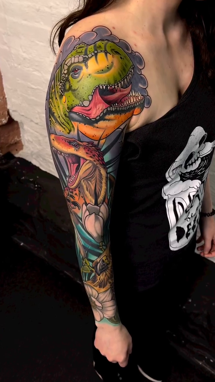 Dinosaur and animal sleeve neo-traditional tattoo by Bradley Dozier