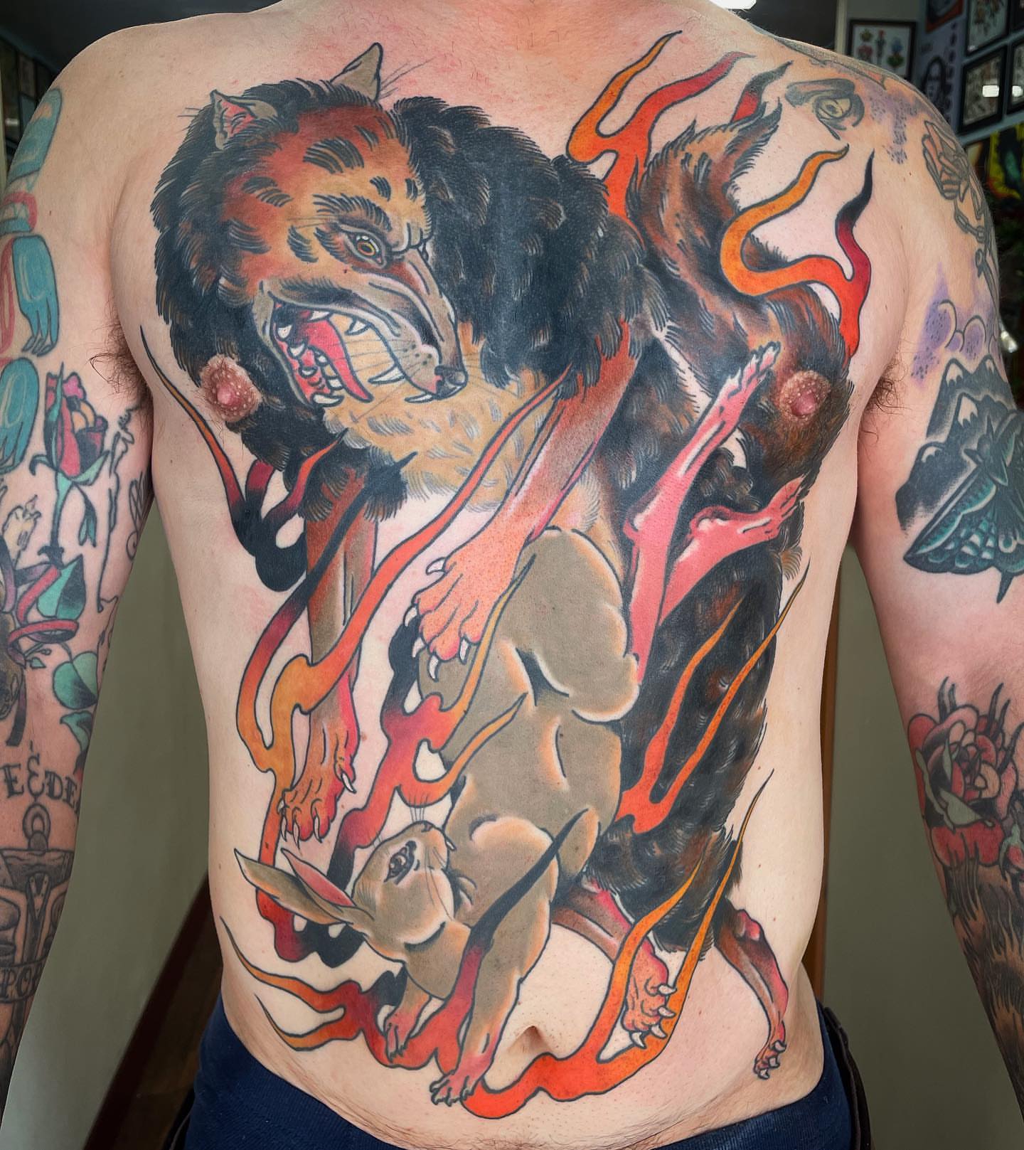 Tiger and rabbit American traditional tattoo on the back by Blake Brand