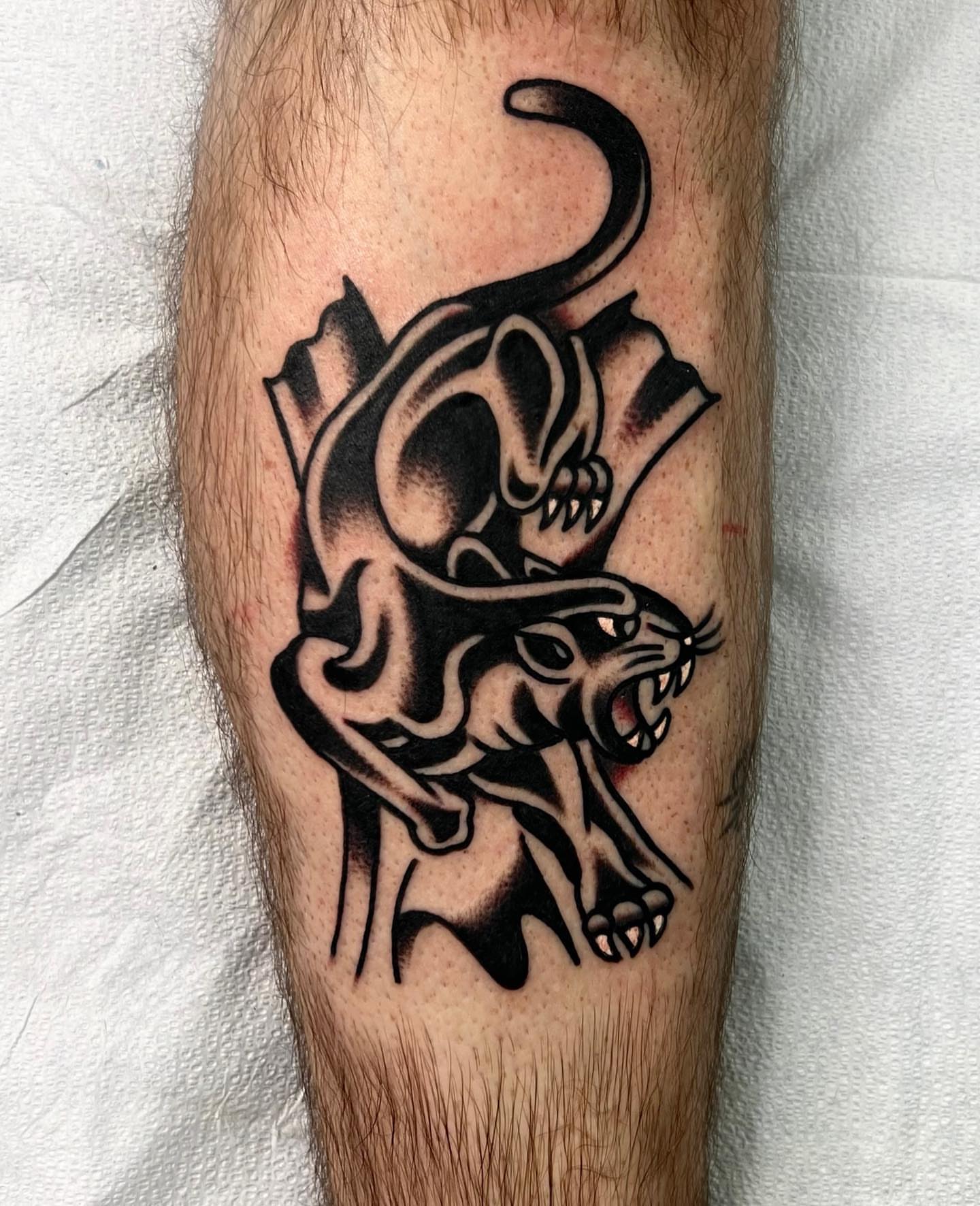 Panther and skull black and grey tattoo on the forearm by Nicholas Mella, Nashville, Tennessee