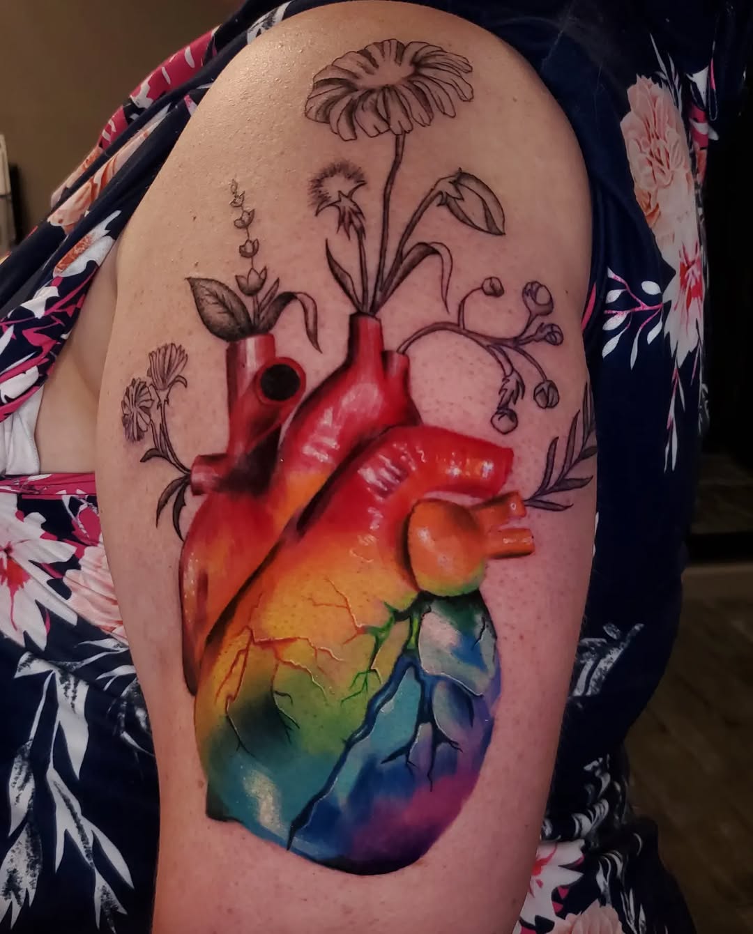 Anatomical heart with flowers watercolor tattoo on the shoulder by BoogaInk