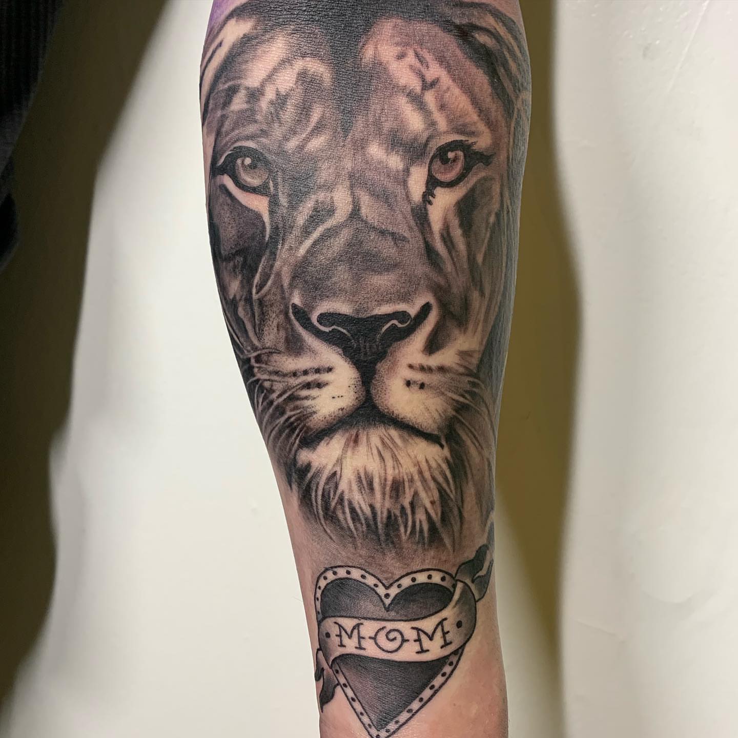 Lion realism tattoo on the forearm by ATLANTA Queer Tattooer