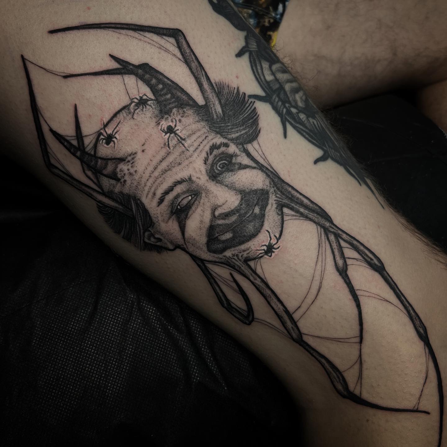 Man's face with horns dotwork tattoo on the forearm by Kyle Black