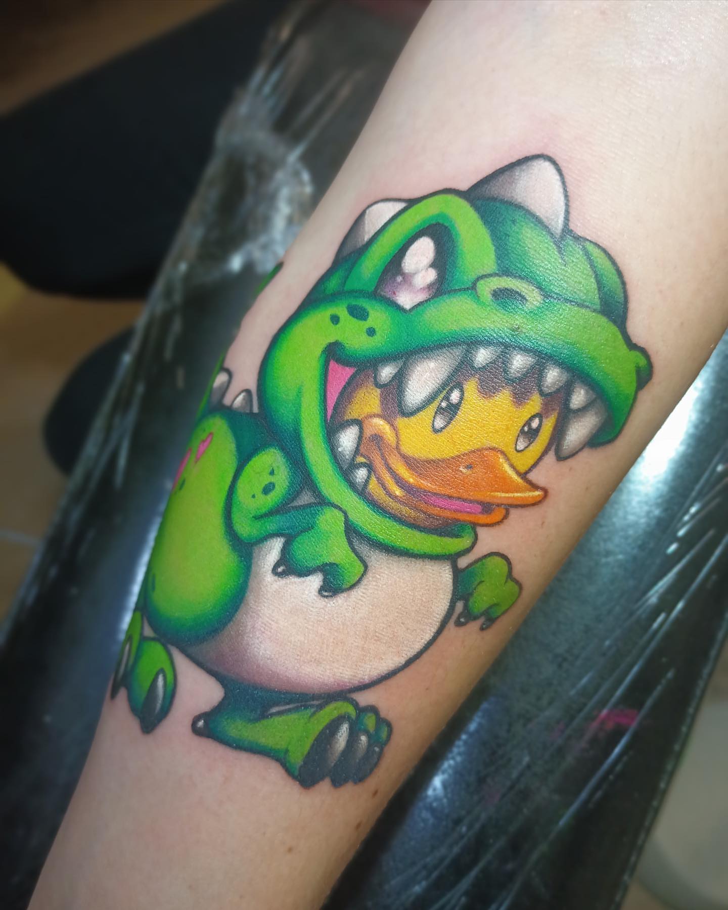 Chameleon and duckling new school tattoo on the forearm by Angell Tattoo Artist, Denver, Colorado