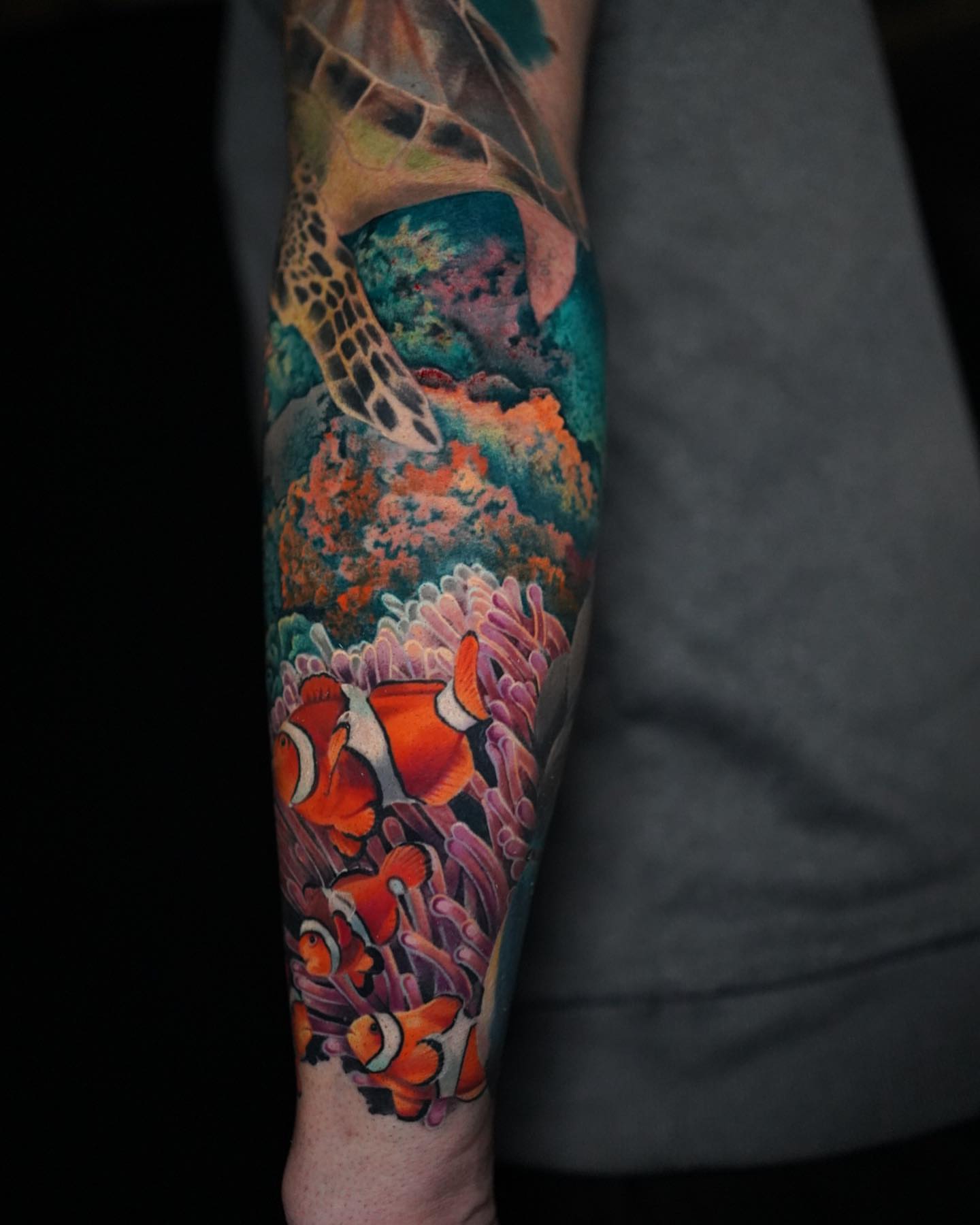 Clownfish and coral reef new school tattoo on the forearm by Danny Madsen