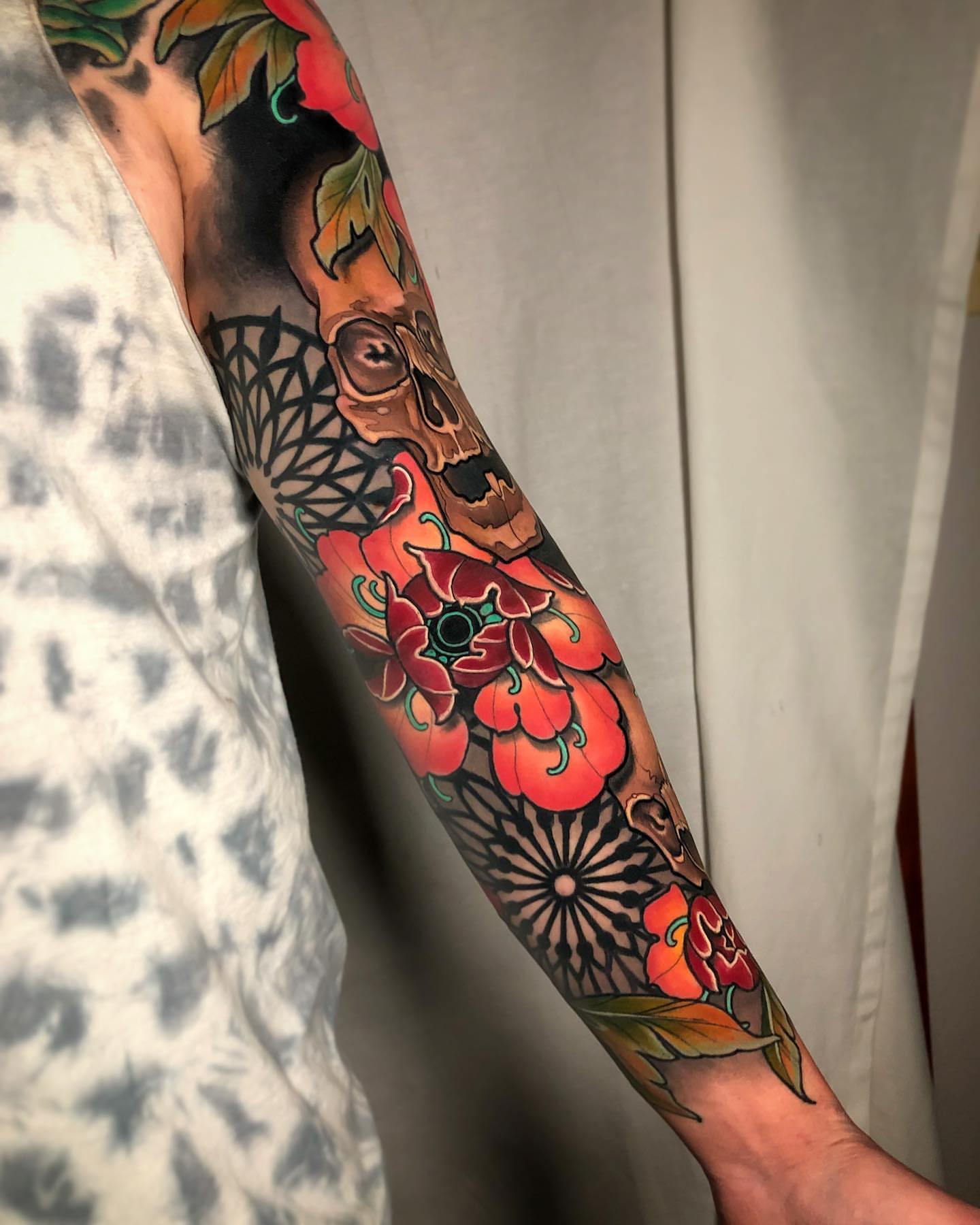 Floral skull American traditional tattoo on the forearm by Milo Alfring Tattoo