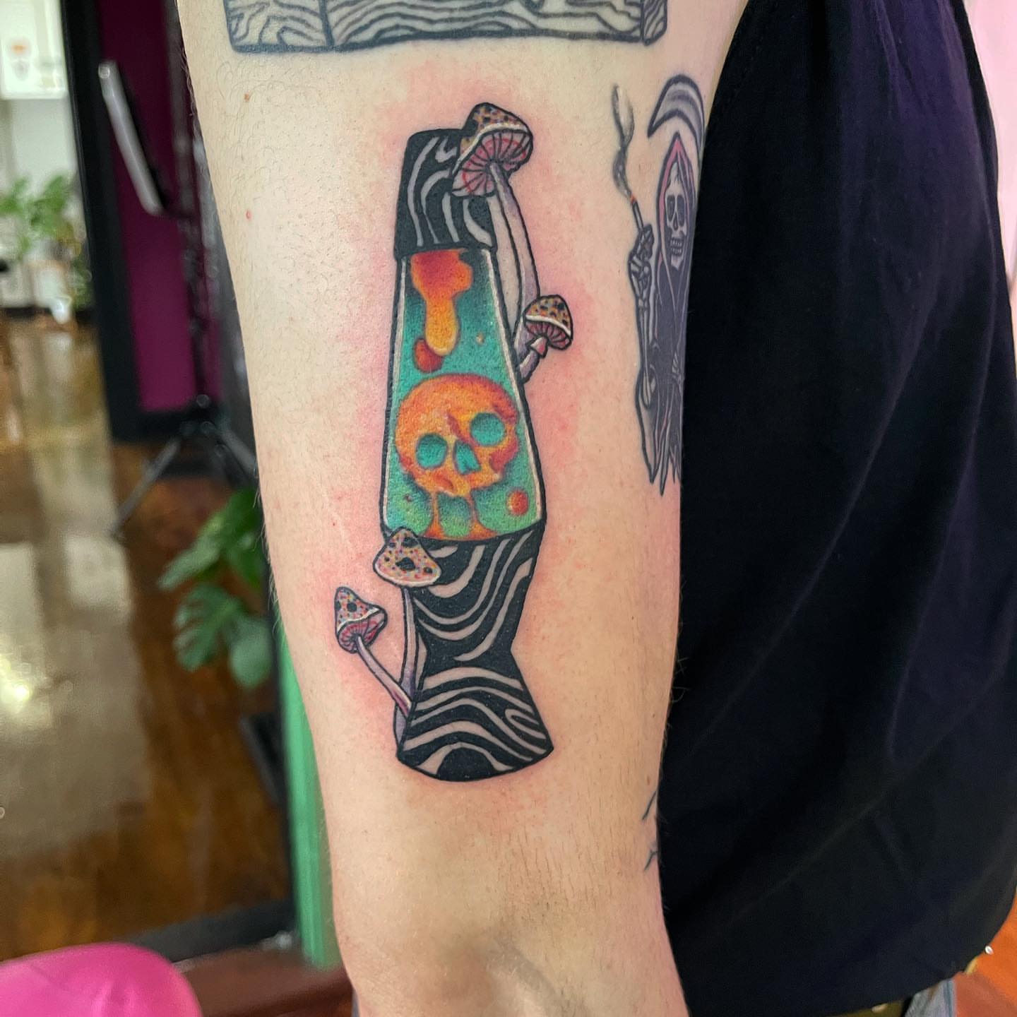 Lava lamp with skull new school tattoo on the forearm by Erin Miller