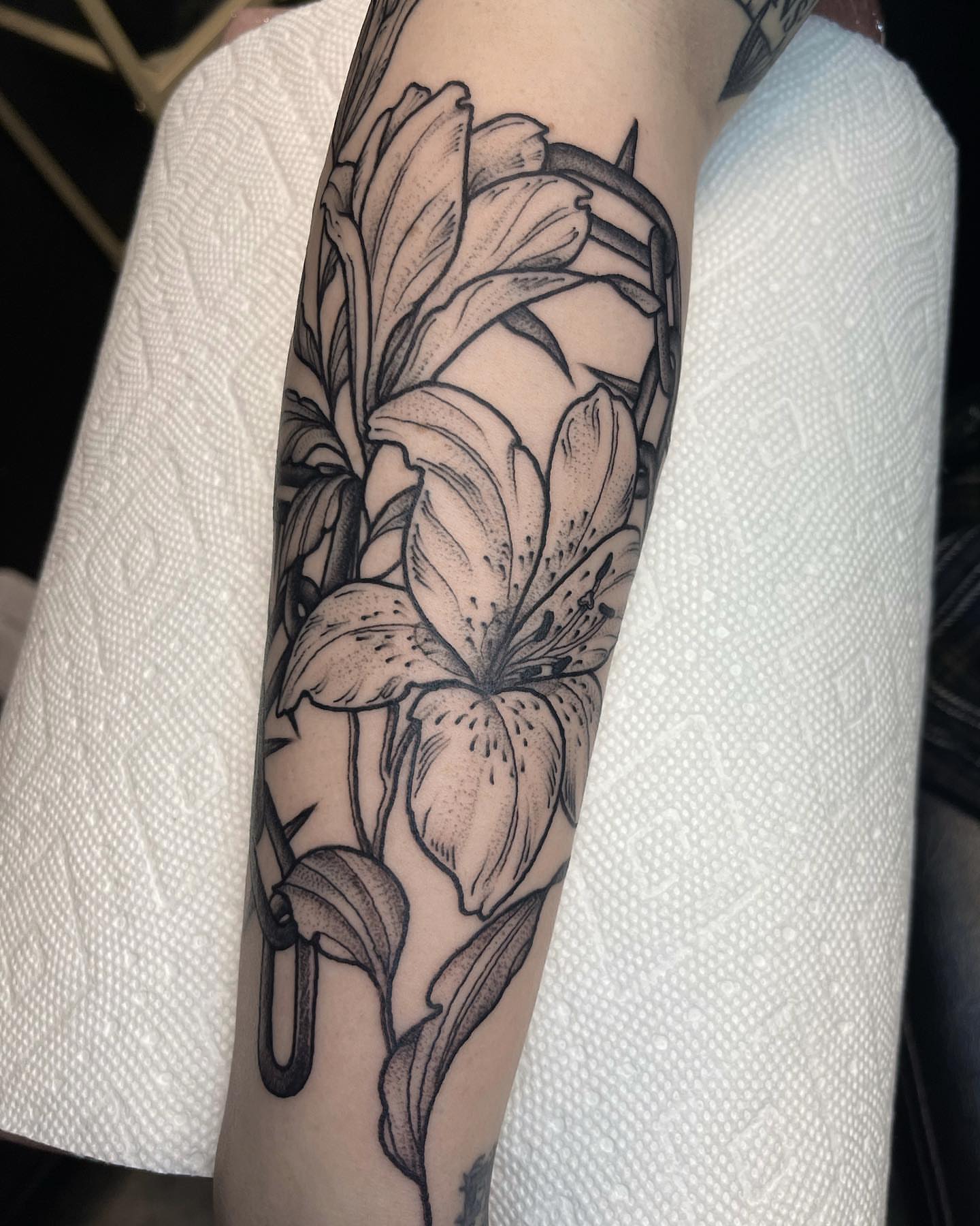 Lily black and grey tattoo on the forearm by 𝐀𝐘𝐀𝐍𝐀𝐇