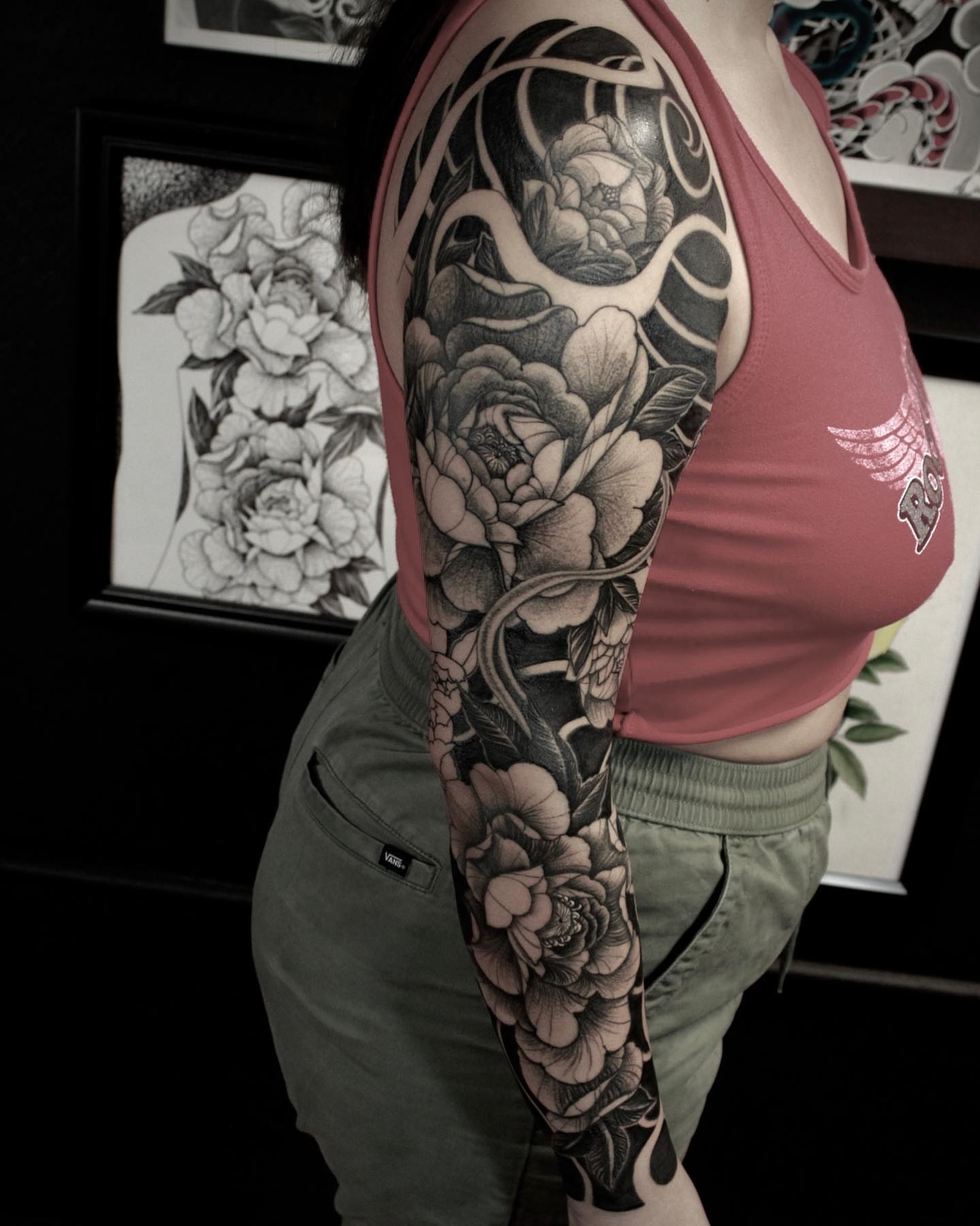 Peony and snake realism tattoo on the upper arm by Daniel Gutierrez
