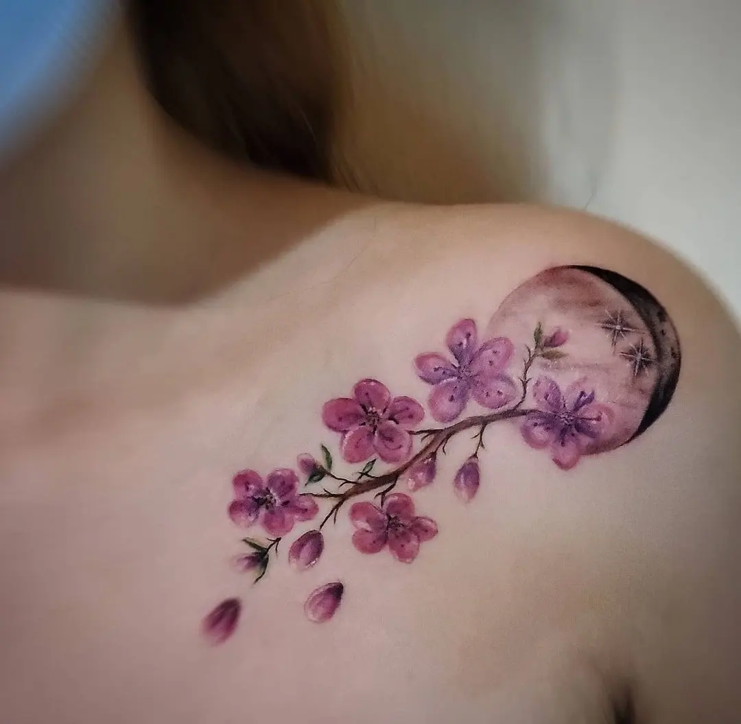 Cherry blossom branch watercolor tattoo on the shoulder by William Gualteros