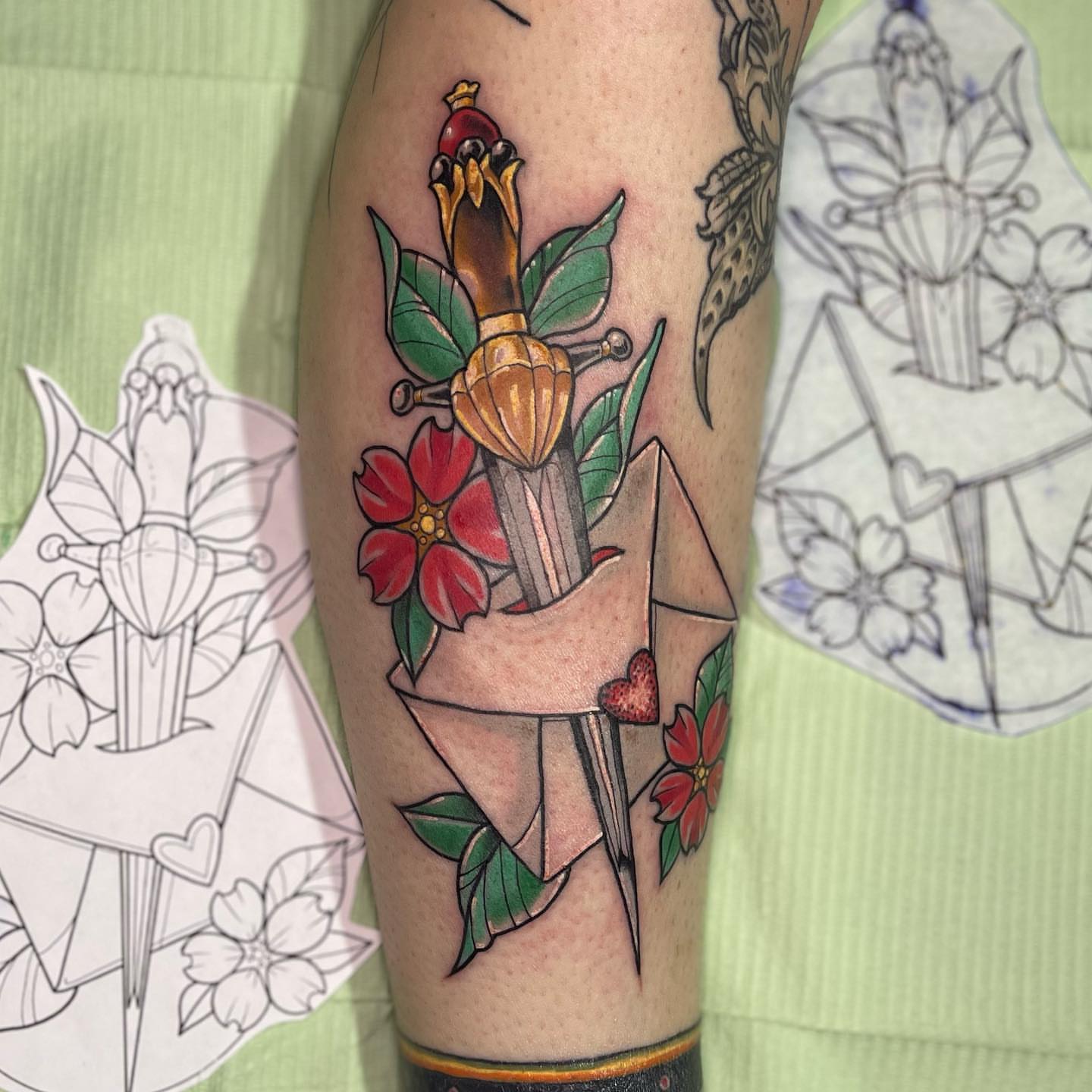 Origami sword and flowers American traditional tattoo on the forearm by Sarah Bobby, Houston, Texas