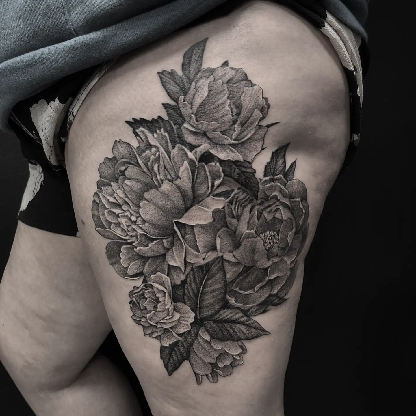 Peonies realism tattoo on the thigh by Kyle Joseph [tattoo artist]