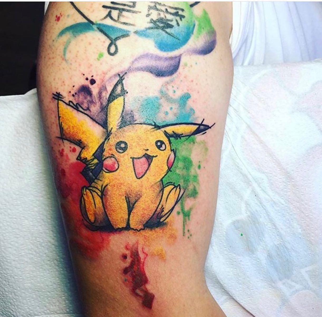 Pikachu watercolor tattoo on the forearm by Shamanic Ink