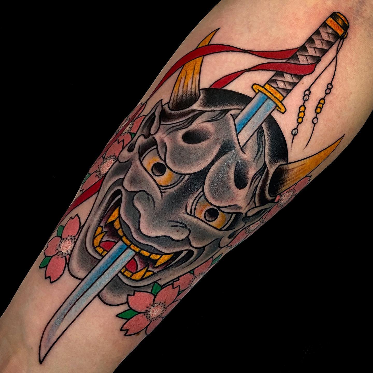 Mask and katana American traditional tattoo on the forearm by Erick Lynch, Cambridge, Massachusetts