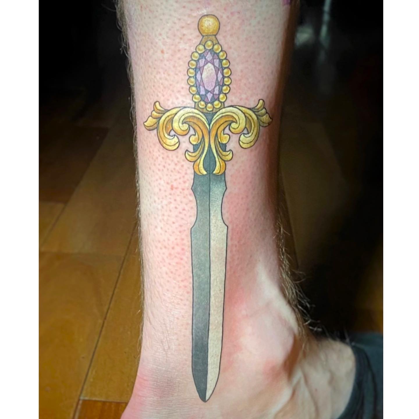 Sword ornamental tattoo on the foot by Alicia