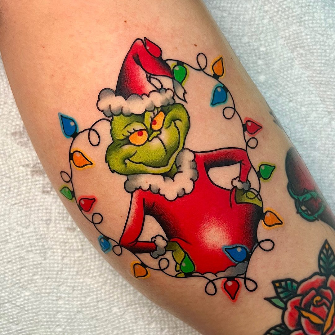 The grinch American traditional tattoo on the forearm by Shelby Ouellette