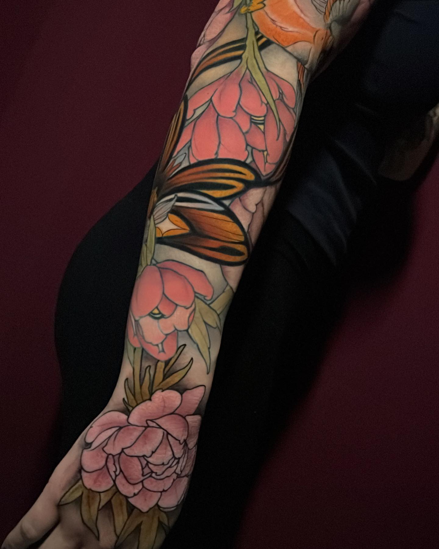 Flowers and butterfly American traditional tattoo on the forearm by Tony Trophy