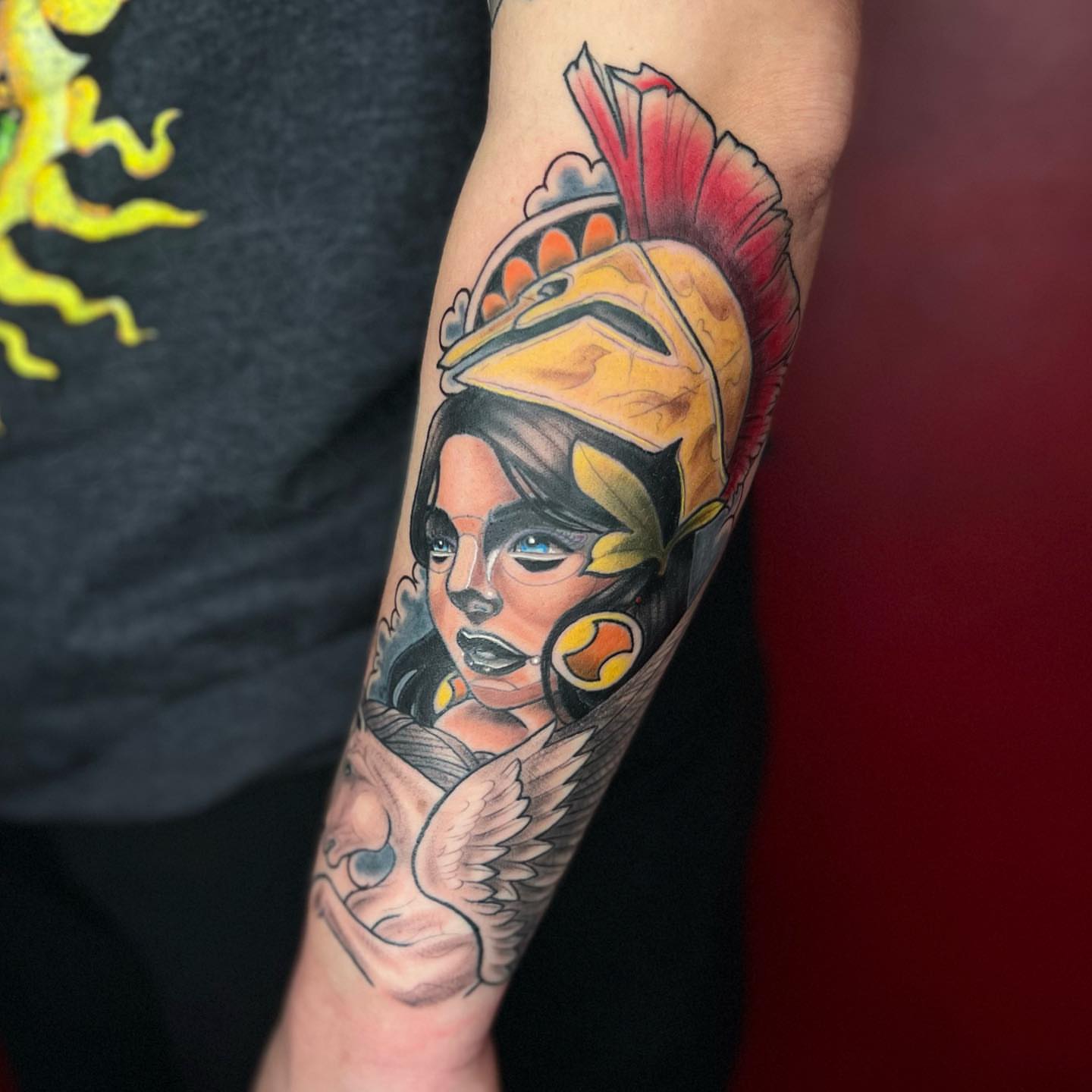 Woman wearing helmet American traditional tattoo on the forearm by Matthew Diaz