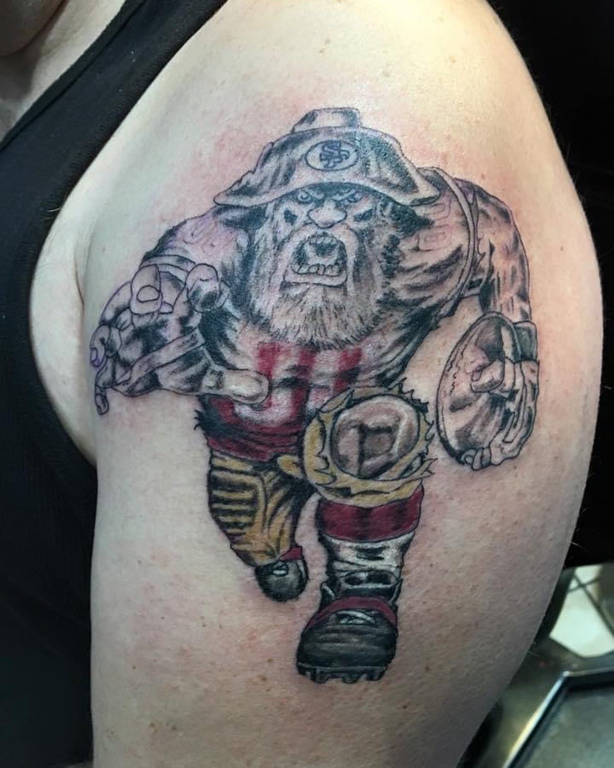 Football player American traditional tattoo on the shoulder by Chris Whittaker Tattoo Artist