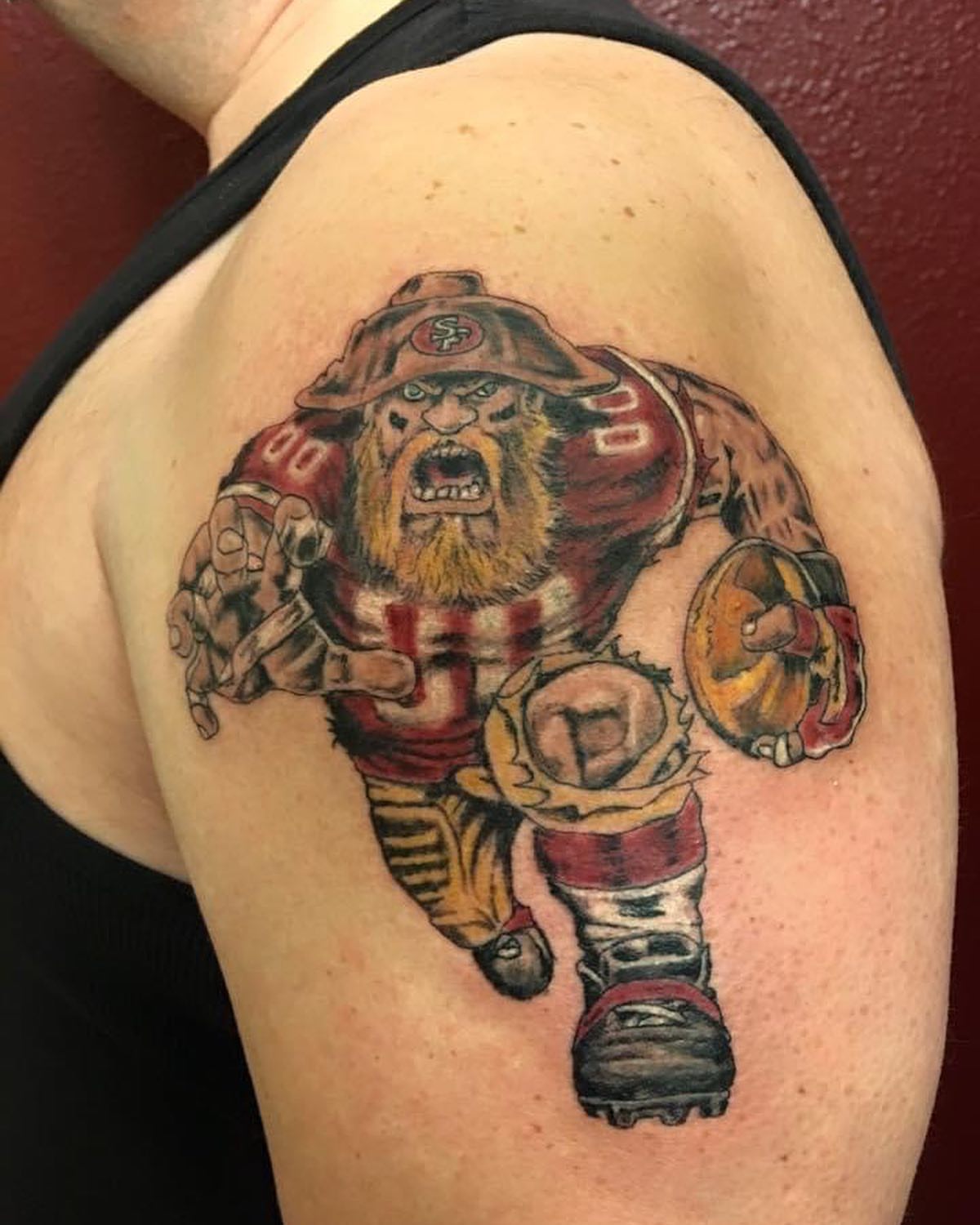 Football player realism tattoo on the shoulder by Chris Whittaker Tattoo Artist