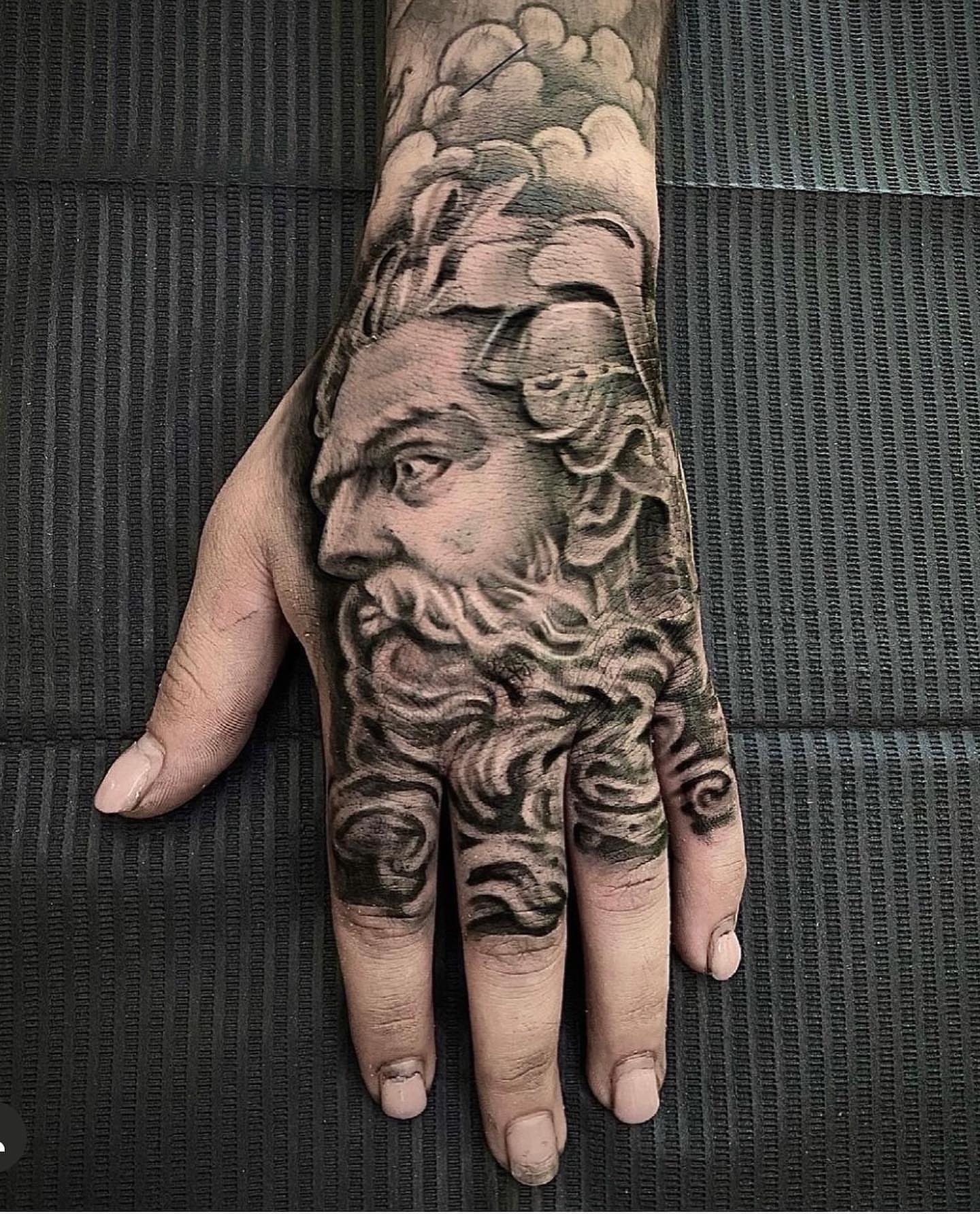 Bearded man realism tattoo on the hand by Shamanic Ink