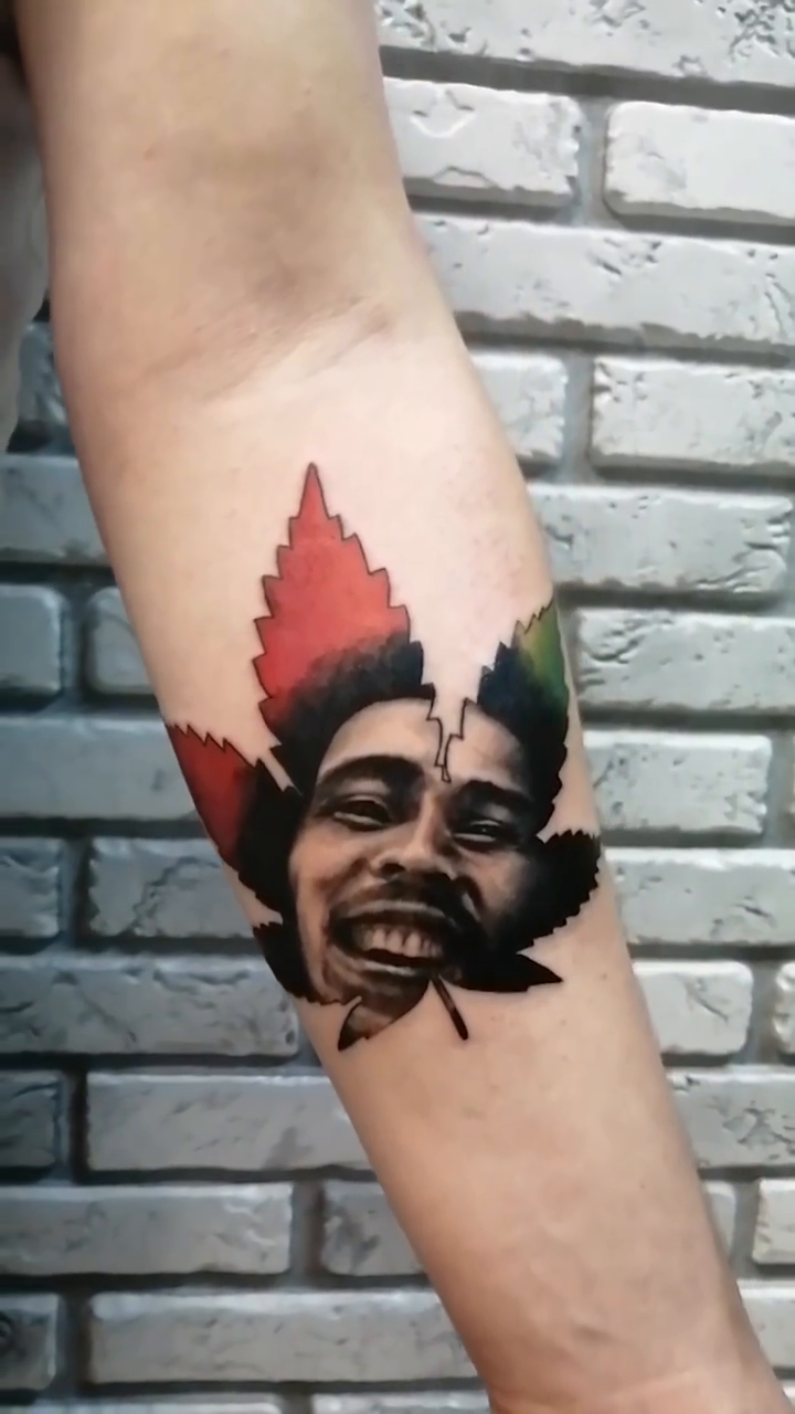 Bob marley and cannabis leaf realism tattoo by Ivan Grinevich