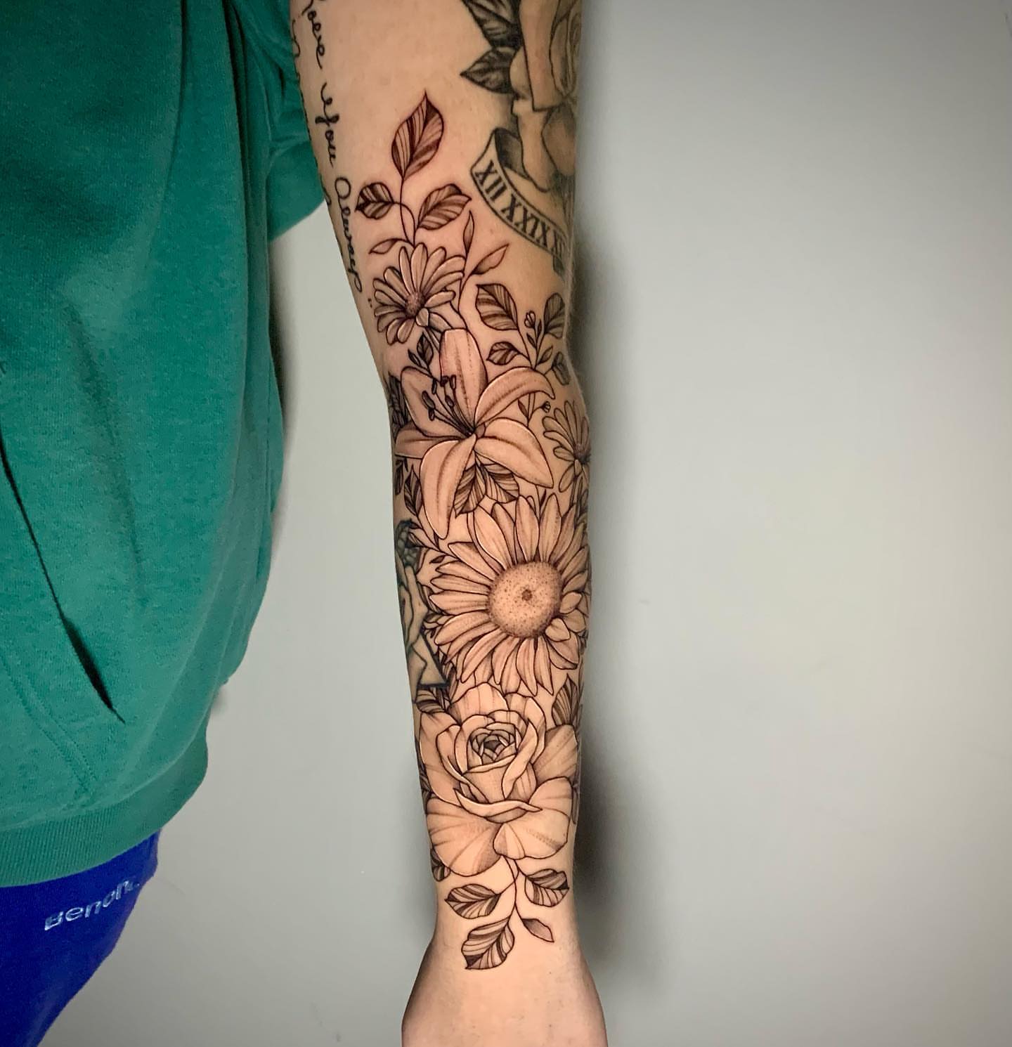 Sunflowers and roses black and grey tattoo on the forearm by Megan McKee Tattoo Artist