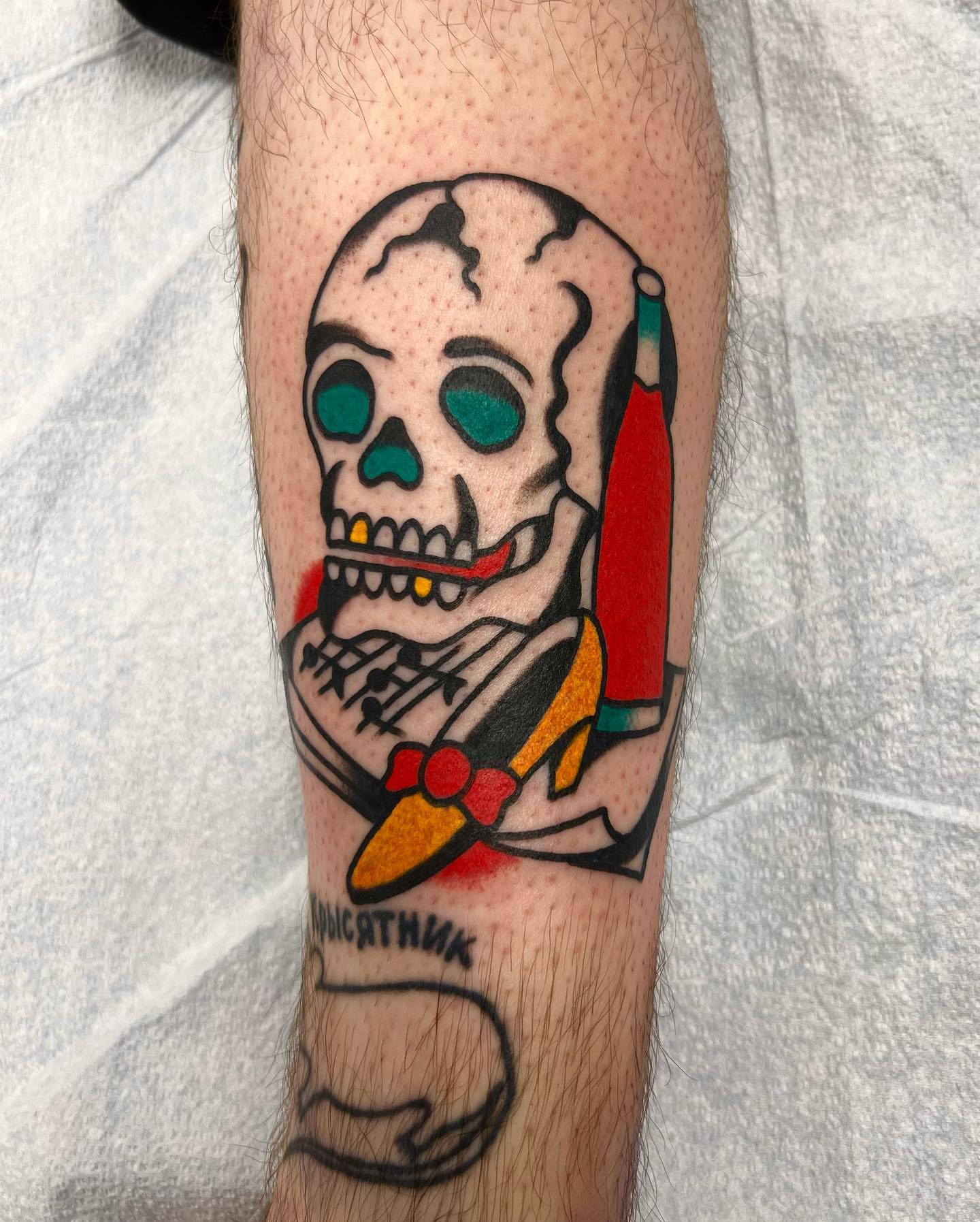Skull with bow tie American traditional tattoo on the forearm by Nicholas Mella, Nashville, Tennessee
